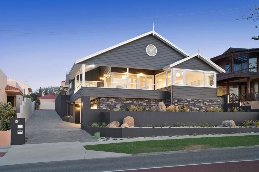 Photo of a beach style split-level grey house exterior in Perth with mixed siding and a gable roof.