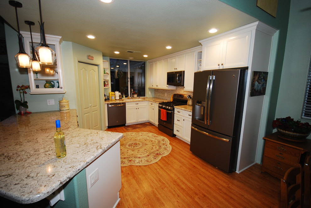 Transitional kitchen photo with flat-panel cabinets and white cabinets