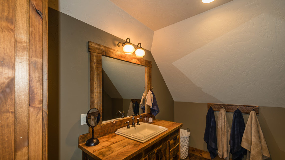Bathroom - mid-sized rustic bathroom idea with recessed-panel cabinets, medium tone wood cabinets, brown walls, a drop-in sink and wood countertops