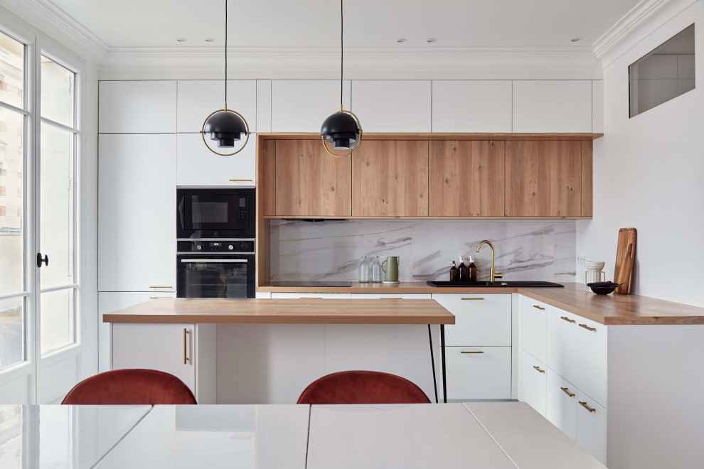 Mid-sized modern l-shaped kitchen in Paris with an undermount sink, beaded inset cabinets, white cabinets, wood benchtops, panelled appliances, marble floors and with island.
