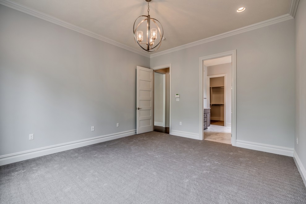 Large transitional master carpeted and gray floor home design photo with gray walls