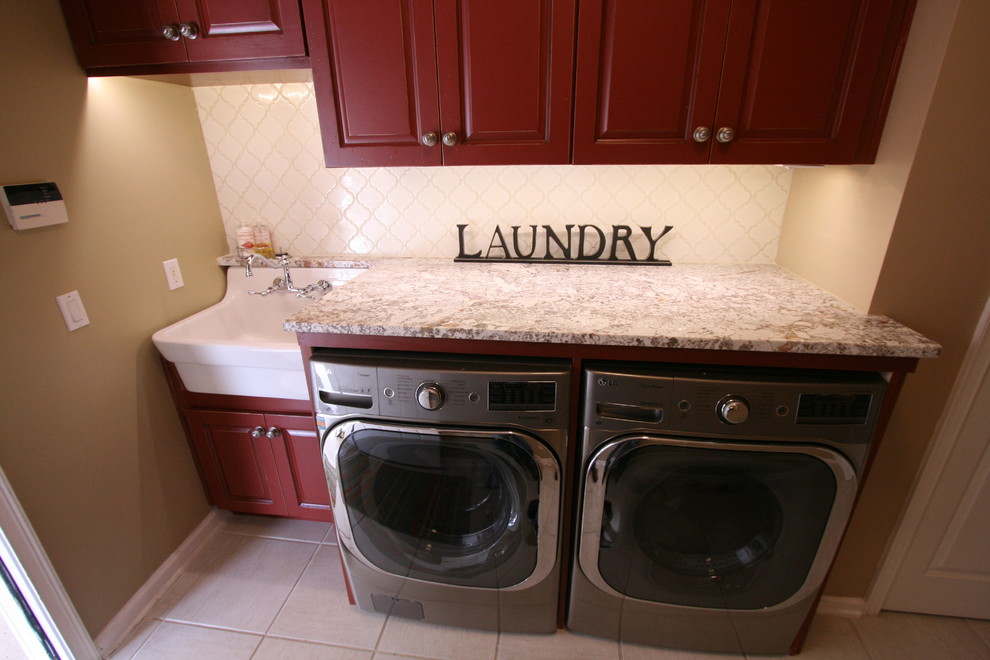 Inspiration for a country l-shaped laundry room in Jacksonville with raised-panel cabinets, dark wood cabinets and a side-by-side washer and dryer.
