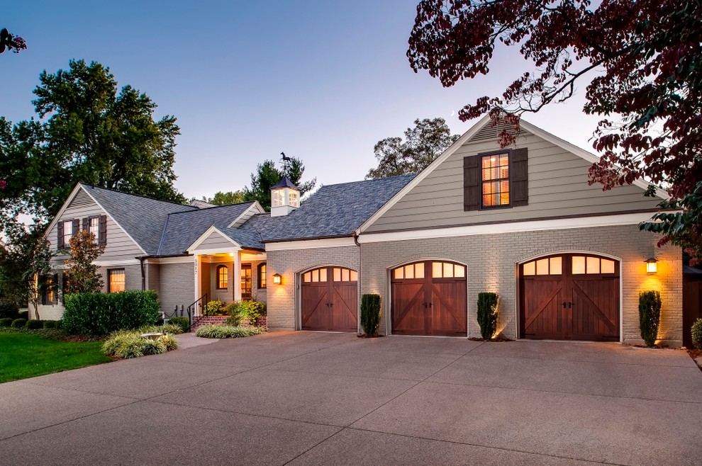 Mid-sized traditional attached three-car garage in Other.