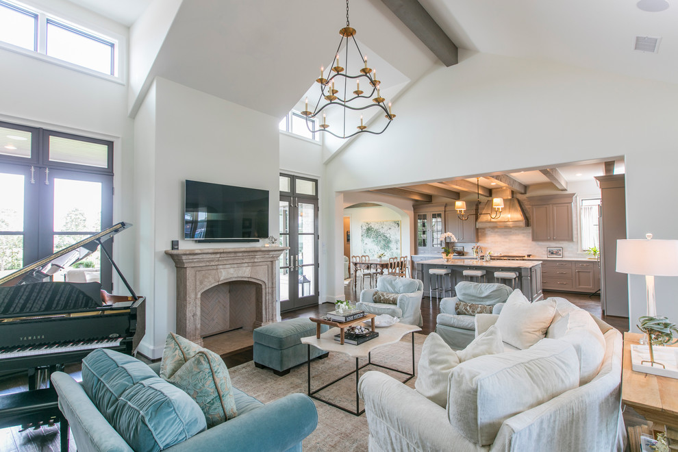 Mid-sized traditional open concept family room in Dallas with white walls, a standard fireplace, a wall-mounted tv, dark hardwood floors and a stone fireplace surround.