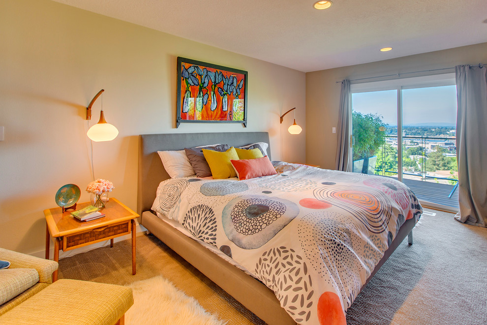 This is an example of a midcentury guest bedroom in Portland with beige walls, carpet and beige floor.
