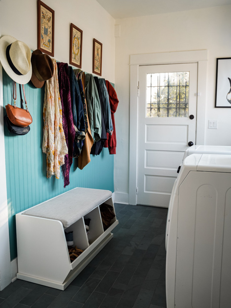 Photo of a small arts and crafts galley utility room in Los Angeles with flat-panel cabinets, white cabinets, slate floors, a side-by-side washer and dryer, green floor and panelled walls.