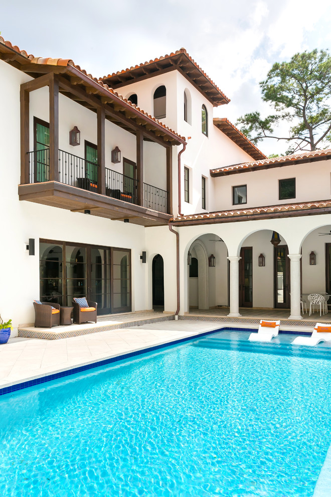 Inspiration for a large mediterranean courtyard rectangular lap pool in Charleston with a hot tub and concrete pavers.