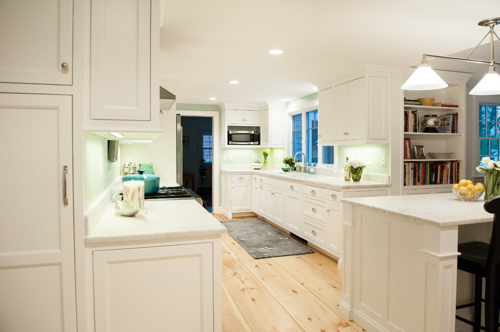 Large traditional galley eat-in kitchen in Portland Maine with an undermount sink, beaded inset cabinets, white cabinets, quartzite benchtops, white splashback, stone slab splashback, stainless steel appliances and with island.
