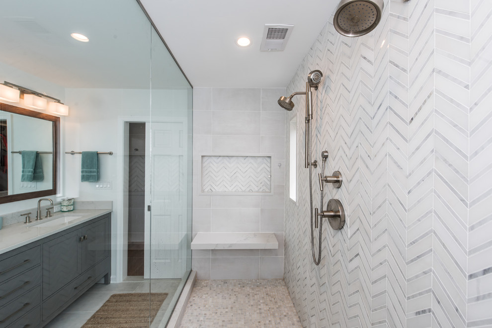 Small traditional master bathroom in DC Metro with recessed-panel cabinets, blue cabinets, an alcove shower, porcelain tile, grey walls, porcelain floors, an undermount sink, engineered quartz benchtops, multi-coloured floor, a sliding shower screen and grey benchtops.