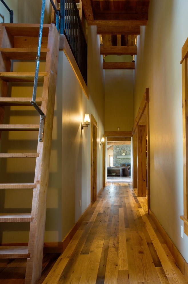 Country hallway in Other with beige walls, medium hardwood floors and yellow floor.