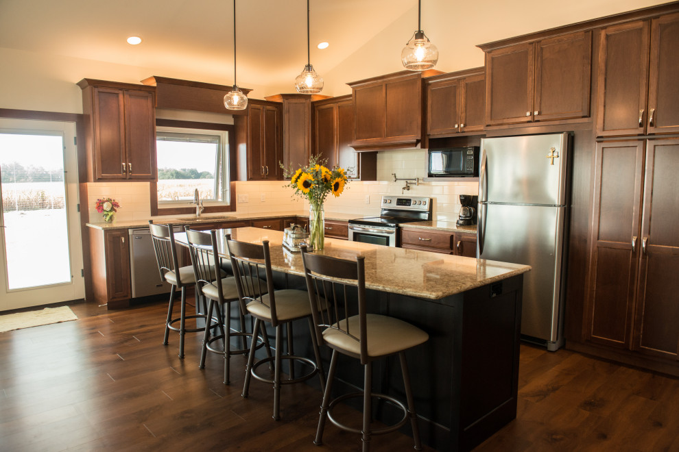 Open concept kitchen - large transitional l-shaped medium tone wood floor open concept kitchen idea with an undermount sink, flat-panel cabinets, medium tone wood cabinets, quartz countertops, white backsplash, ceramic backsplash, stainless steel appliances, an island and multicolored countertops