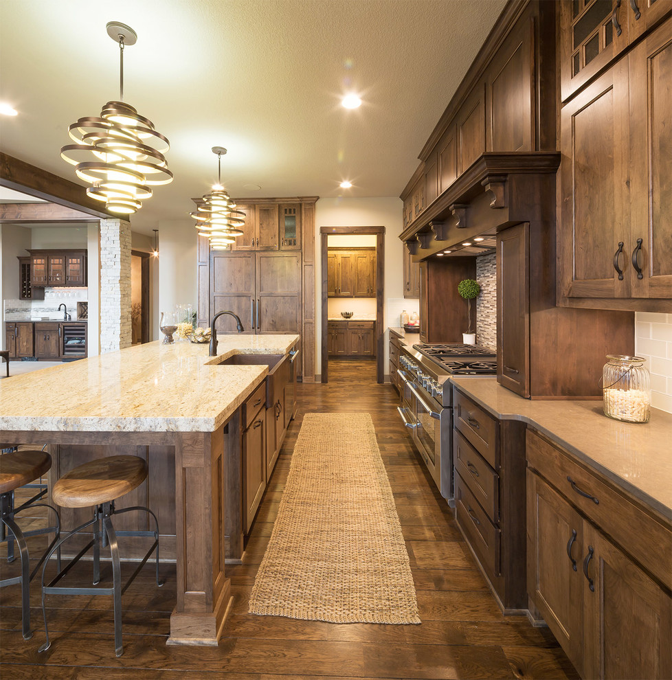 Photo of a country kitchen in Dallas with a farmhouse sink, shaker cabinets, dark wood cabinets, beige splashback, subway tile splashback, dark hardwood floors and with island.
