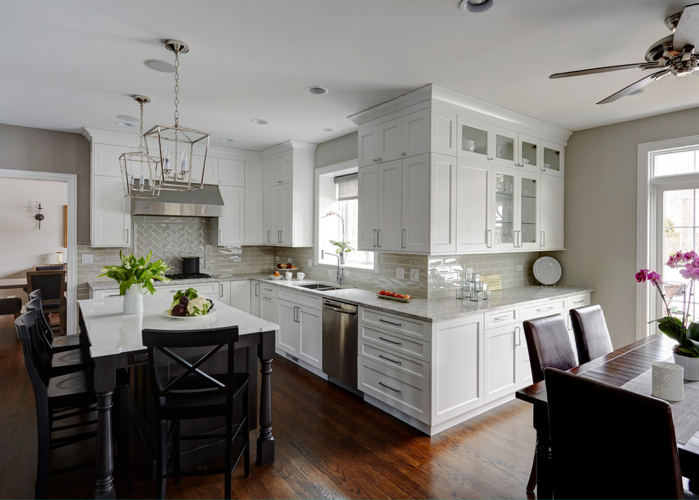 Open concept kitchen - large transitional u-shaped medium tone wood floor open concept kitchen idea in Chicago with a double-bowl sink, flat-panel cabinets, white cabinets, quartz countertops, beige backsplash, subway tile backsplash, stainless steel appliances and an island