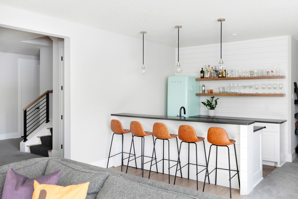 Transitional home bar in Minneapolis with carpet and grey floor.