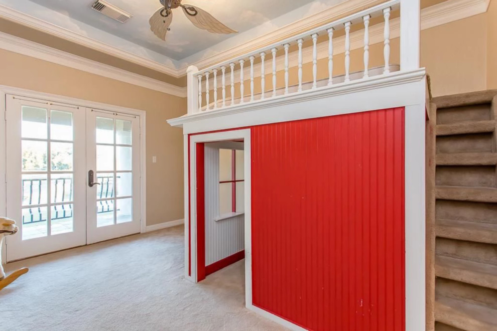 This is an example of an expansive traditional kids' playroom for kids 4-10 years old in Houston with multi-coloured walls, carpet and beige floor.