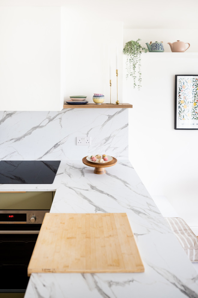 Inredning av ett modernt mellanstort kök, med vitt stänkskydd och stänkskydd i marmor