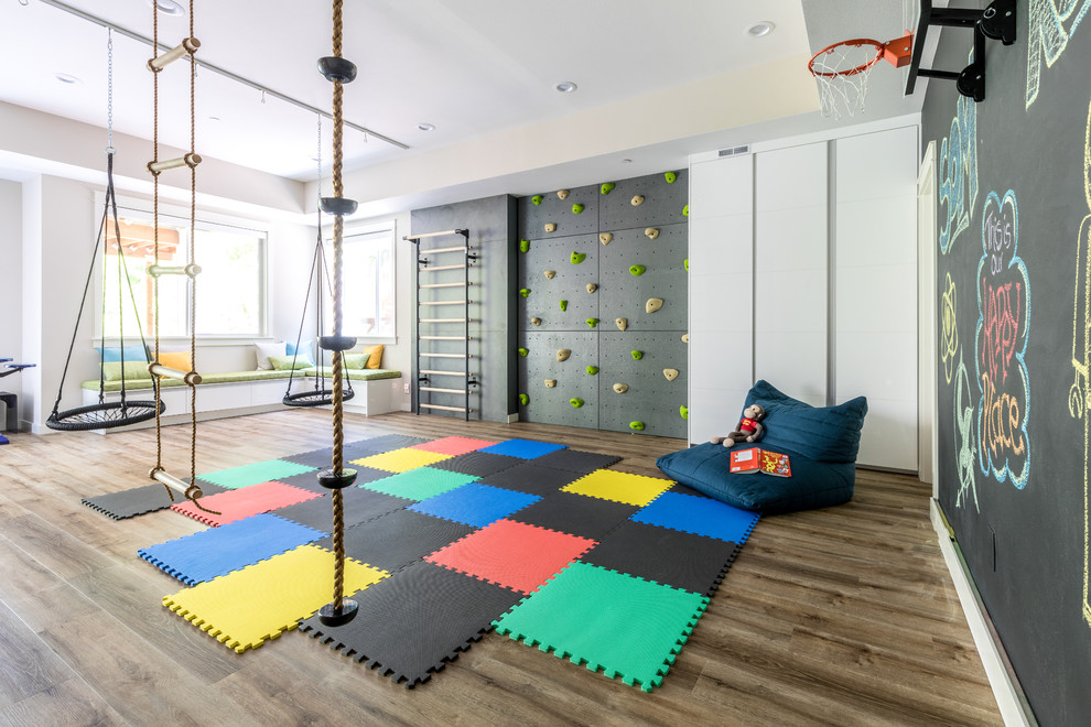 Expansive contemporary gender-neutral kids' playroom in Seattle with black walls, dark hardwood floors and brown floor for kids 4-10 years old.