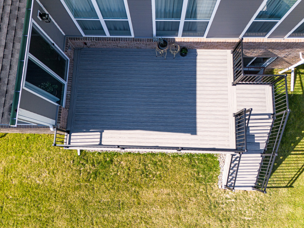 Deck - mid-sized contemporary backyard ground level metal railing deck idea with no cover