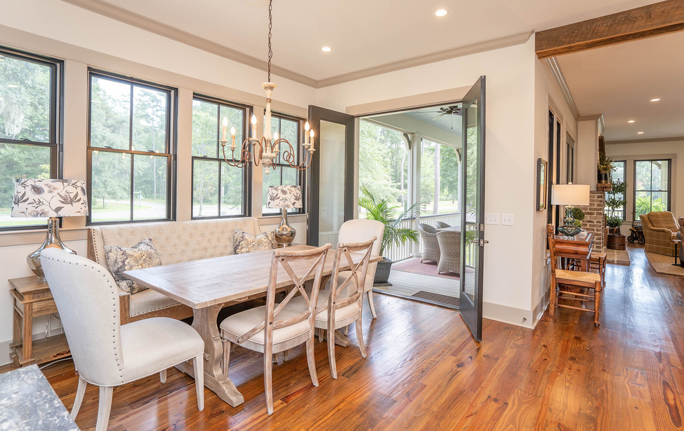 Country dining room in Atlanta with white walls, medium hardwood floors and brown floor.