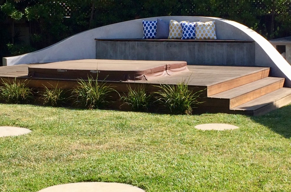 Photo of a small contemporary backyard custom-shaped aboveground pool in Los Angeles with a hot tub and decking.
