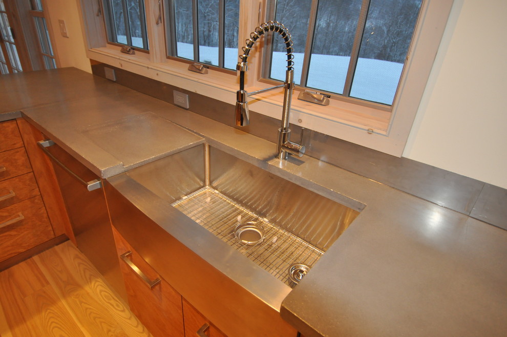 Open concept kitchen - large transitional l-shaped light wood floor and beige floor open concept kitchen idea in Boston with a farmhouse sink, flat-panel cabinets, dark wood cabinets, stainless steel countertops, stainless steel appliances and no island