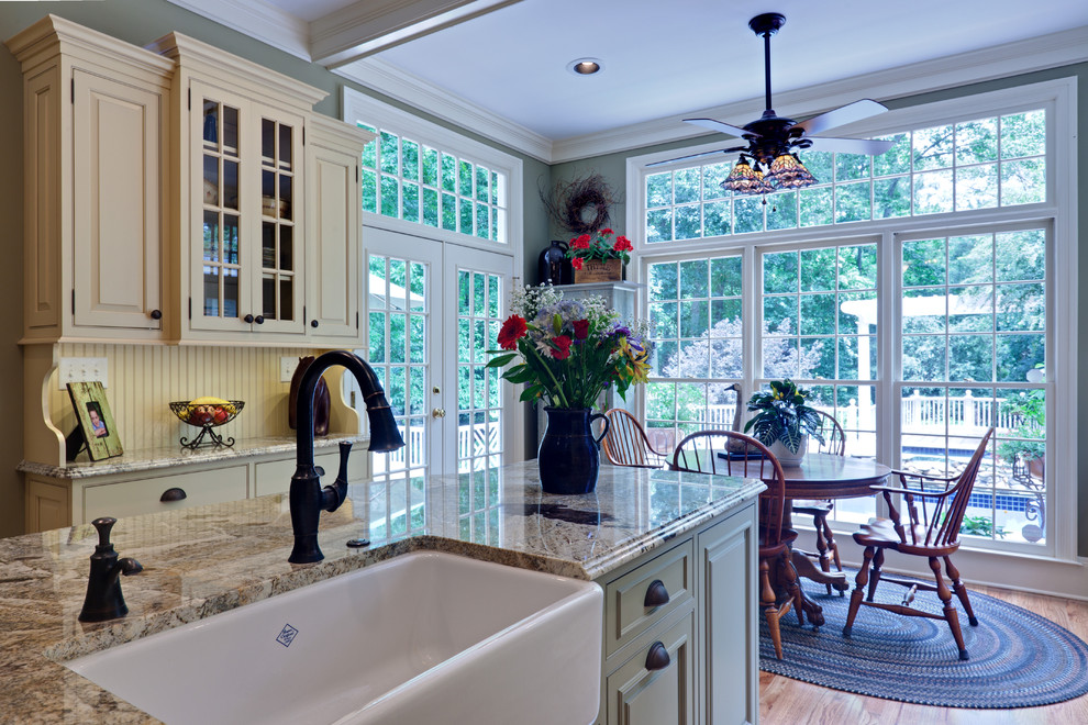 This is an example of a traditional eat-in kitchen in Atlanta with a farmhouse sink.