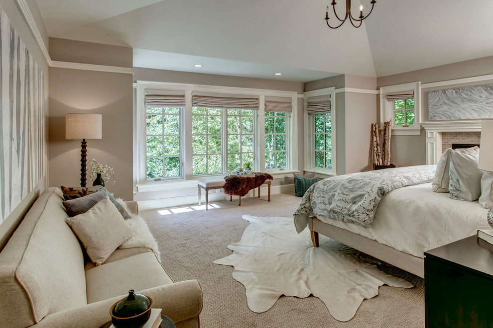 Large transitional master bedroom in Seattle with beige walls, carpet, a standard fireplace, a brick fireplace surround and beige floor.