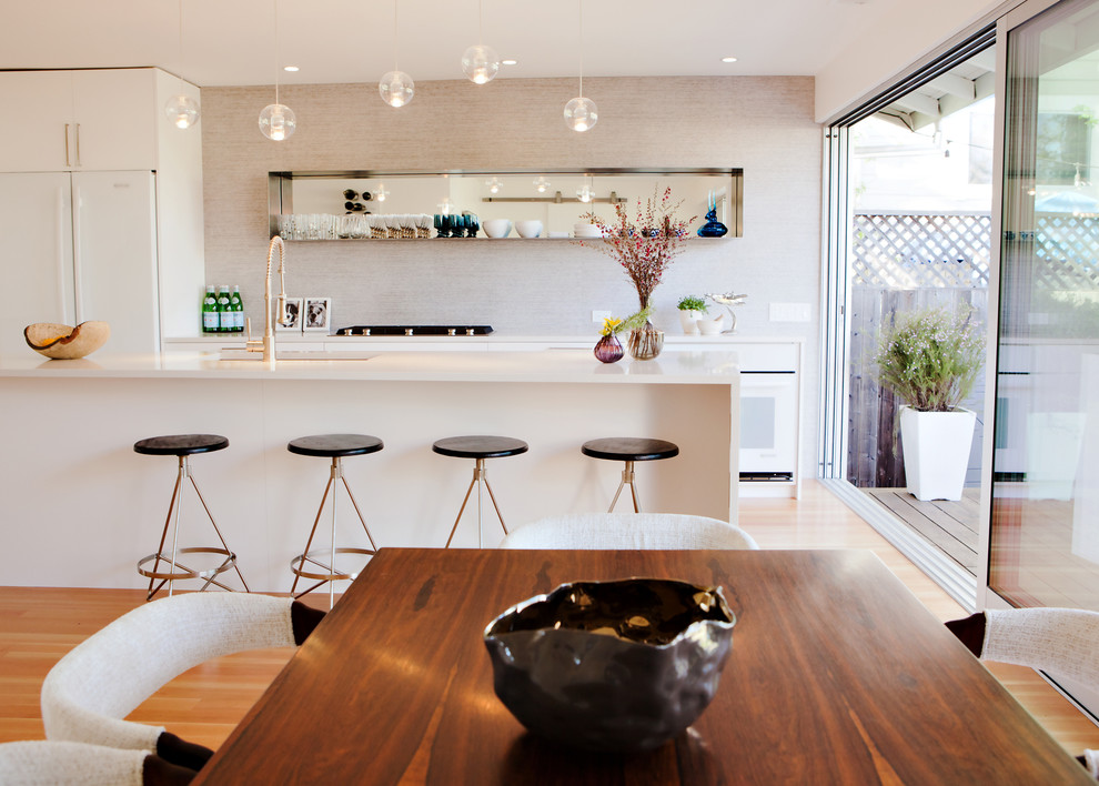 Photo of a small modern eat-in kitchen in San Francisco with light hardwood floors.