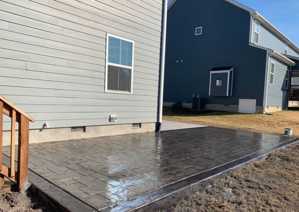 Mid-sized transitional backyard stamped concrete patio photo with no cover