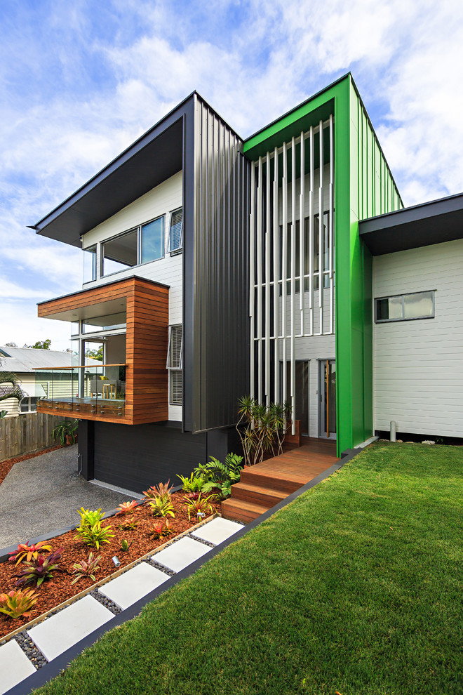 Inspiration for a contemporary three-storey exterior in Brisbane with a shed roof.