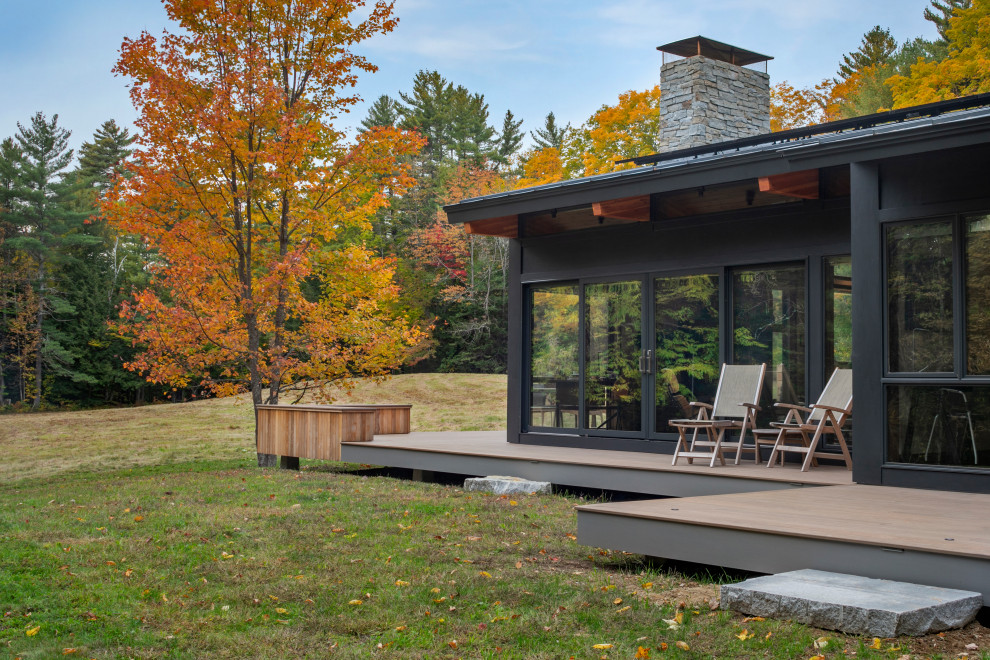 Inspiration for a small 1950s gray one-story concrete fiberboard exterior home remodel in Manchester with a shingle roof