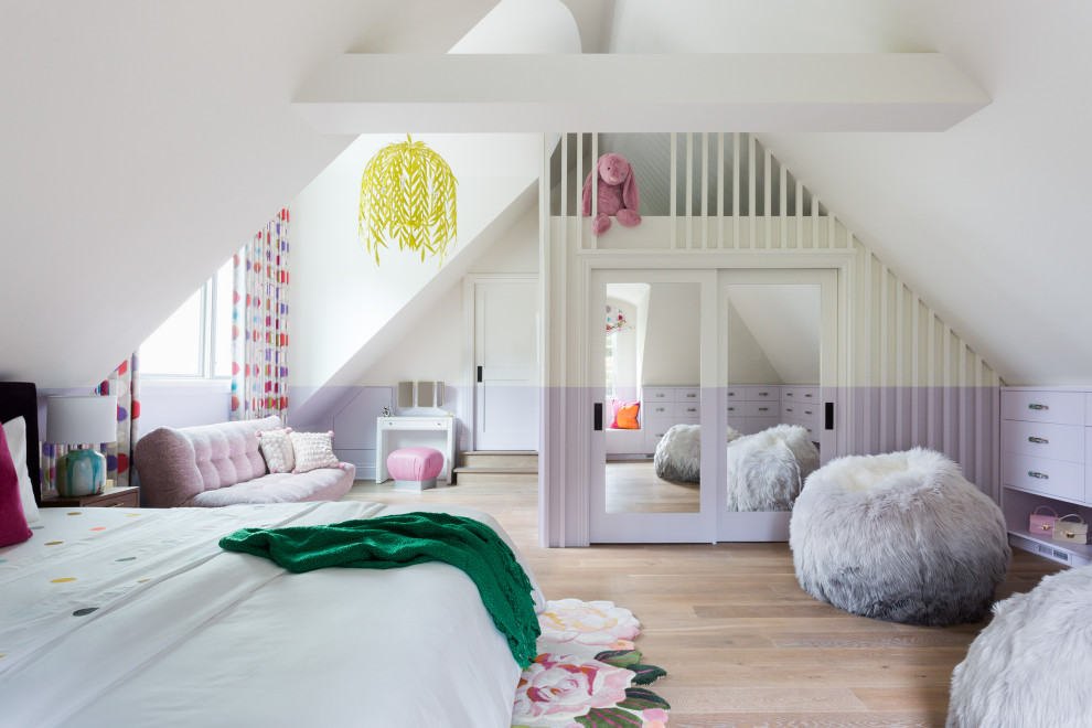 Expansive contemporary kids' room in Houston with multi-coloured walls, light hardwood floors and vaulted for girls.