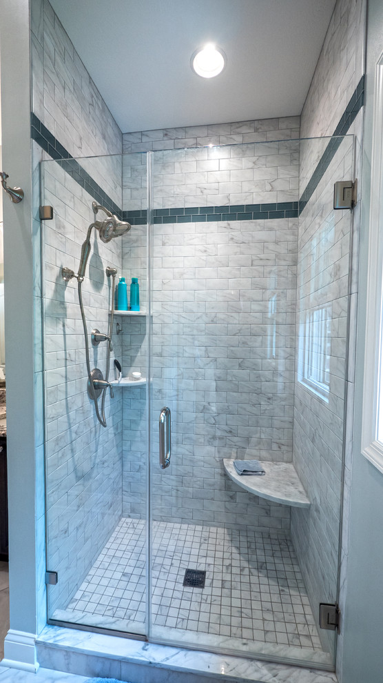 Example of a transitional master white tile and ceramic tile ceramic tile alcove shower design with an undermount sink, raised-panel cabinets, dark wood cabinets, granite countertops and blue walls