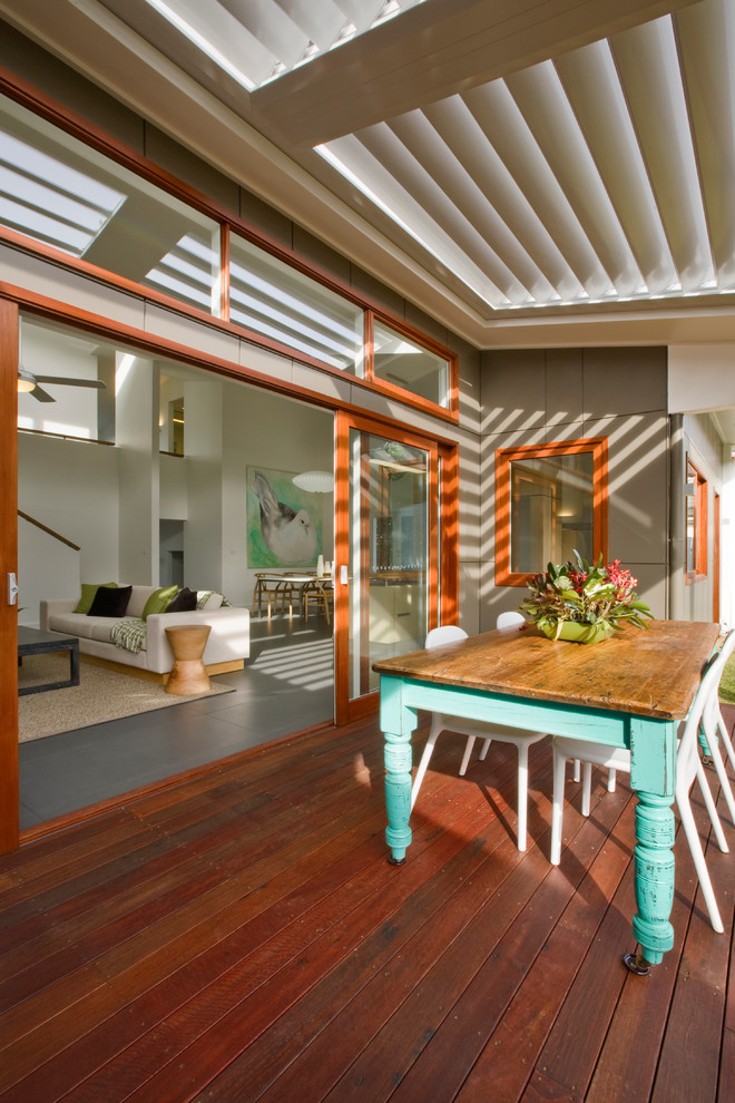 This is an example of a mid-sized modern rooftop deck in Sydney with a roof extension.