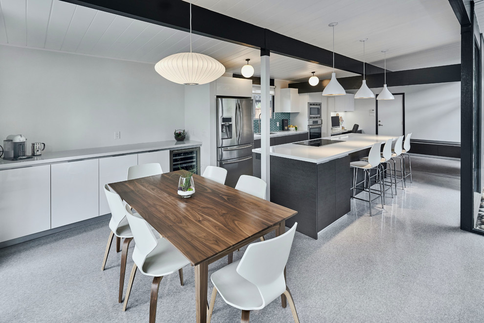 Photo of a large modern single-wall eat-in kitchen in San Francisco with a single-bowl sink, flat-panel cabinets, grey cabinets, quartz benchtops, blue splashback, ceramic splashback, stainless steel appliances, linoleum floors, with island and grey floor.
