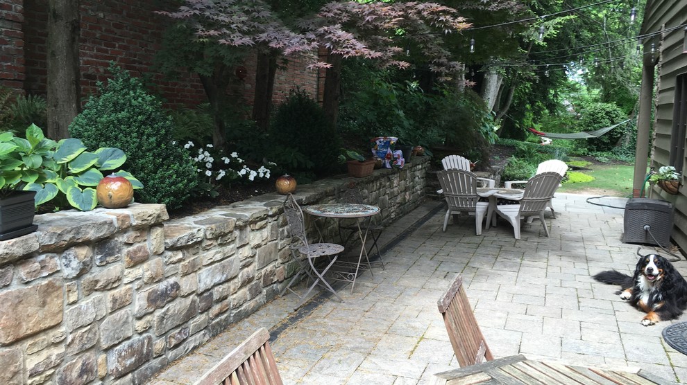 Design ideas for a mid-sized contemporary side yard patio in Other with natural stone pavers and no cover.