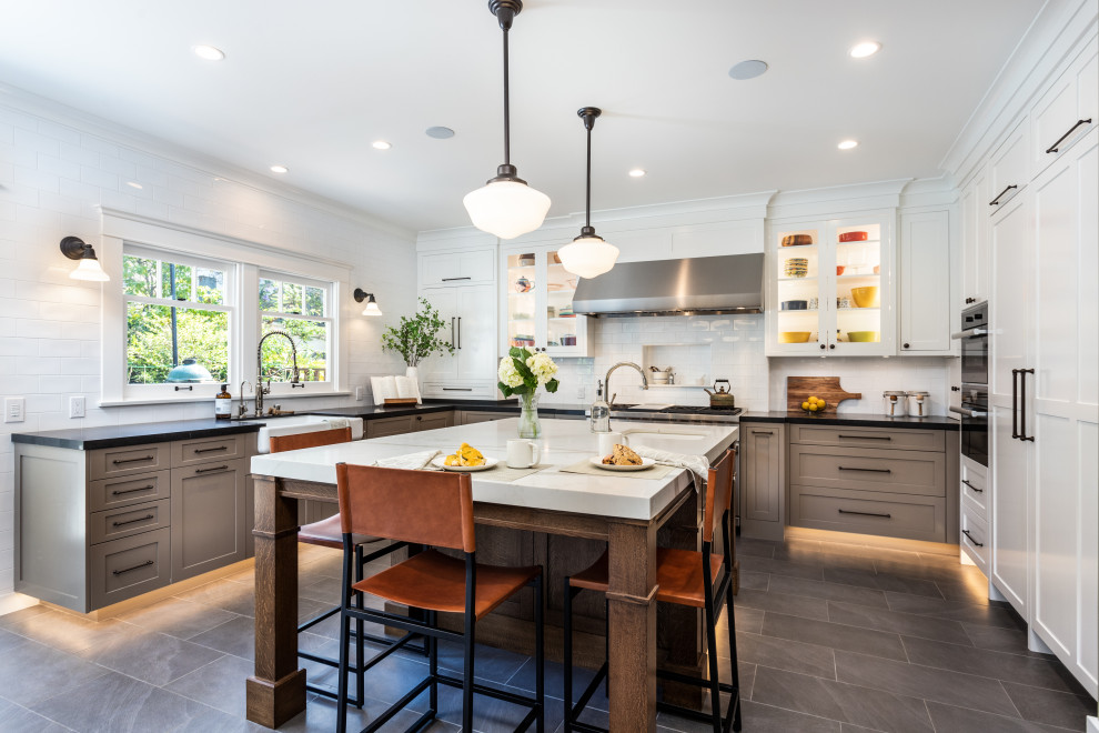 Enclosed kitchen - mid-sized transitional enclosed kitchen idea in Los Angeles with white backsplash, an island and white countertops