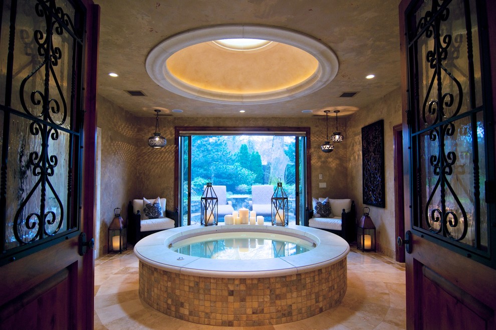 This is an example of a small mediterranean indoor round aboveground pool in Austin with a hot tub and tile.