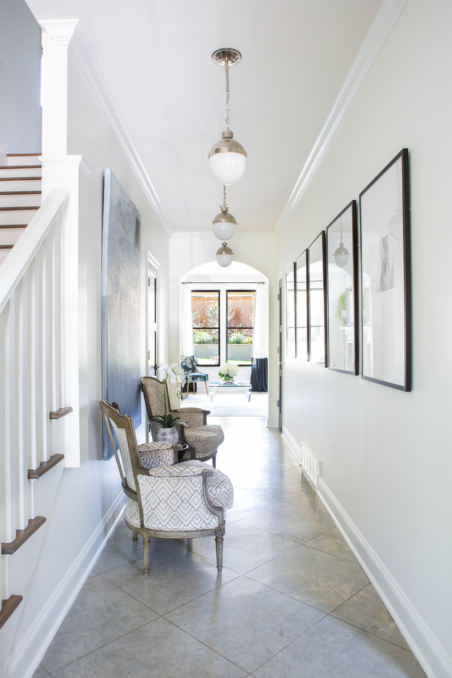 Entry hall - mid-sized transitional concrete floor and beige floor entry hall idea with white walls