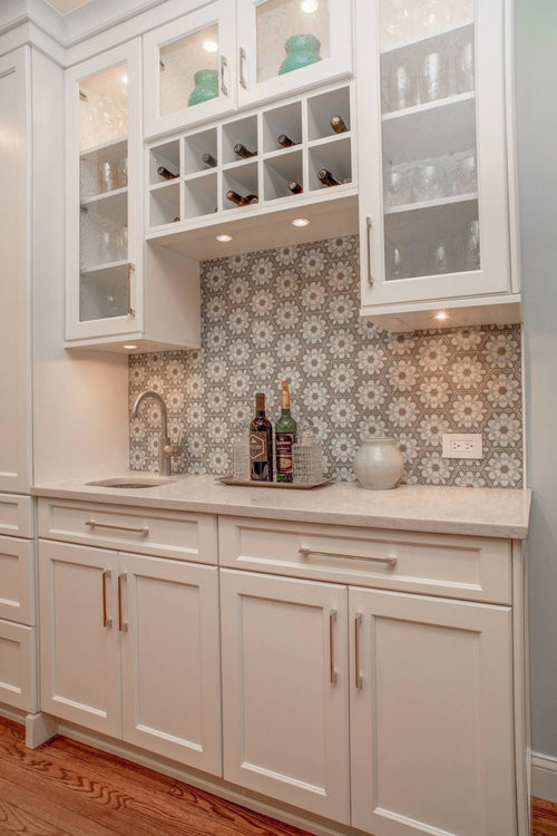 Inspiration for a contemporary home bar in Orlando with an undermount sink, recessed-panel cabinets, white cabinets, quartzite benchtops, multi-coloured splashback, cement tile splashback and medium hardwood floors.