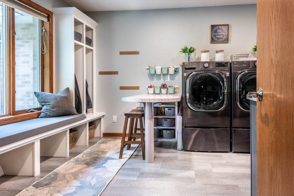 Design ideas for a large contemporary u-shaped utility room in Other with an utility sink, shaker cabinets, brown cabinets, laminate benchtops, blue walls, vinyl floors, a side-by-side washer and dryer and grey benchtop.