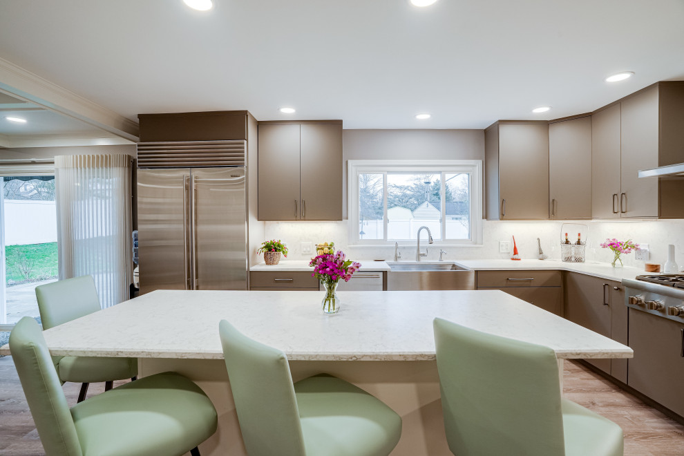 Design ideas for an expansive contemporary u-shaped eat-in kitchen in DC Metro with a farmhouse sink, flat-panel cabinets, brown cabinets, quartz benchtops, engineered quartz splashback, stainless steel appliances and with island.