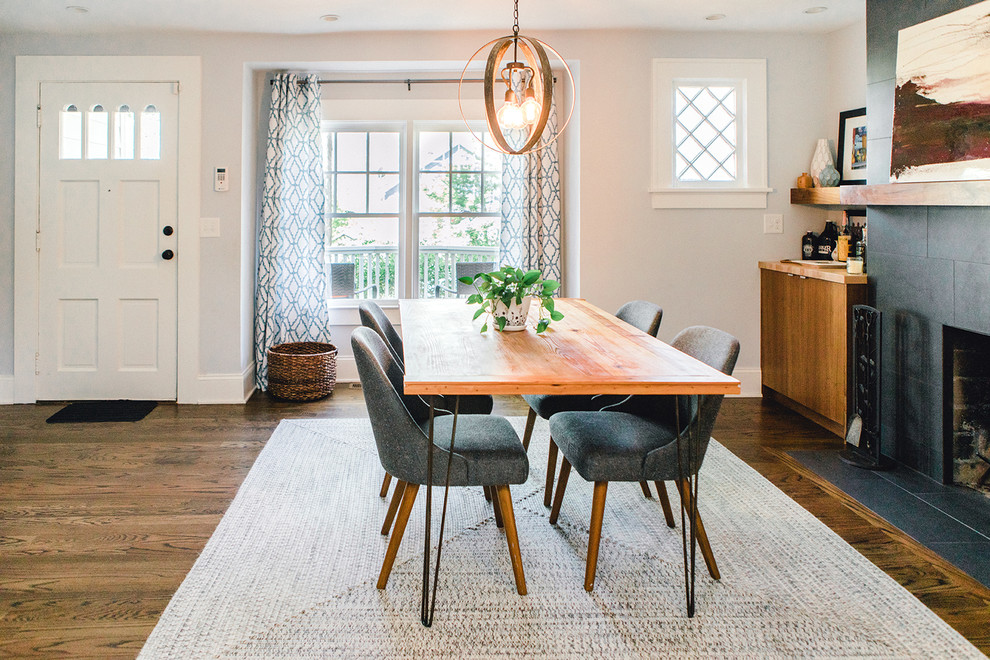 Mid-sized transitional kitchen/dining combo in Atlanta with white walls, dark hardwood floors, a standard fireplace, a tile fireplace surround and brown floor.