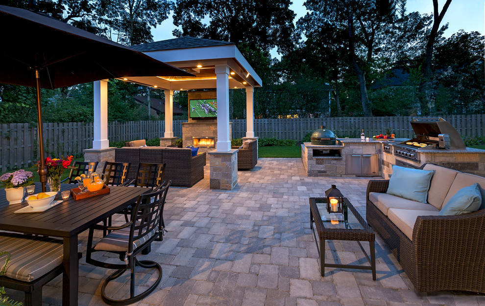 Design ideas for a transitional backyard patio in Chicago with an outdoor kitchen, concrete pavers and a gazebo/cabana.