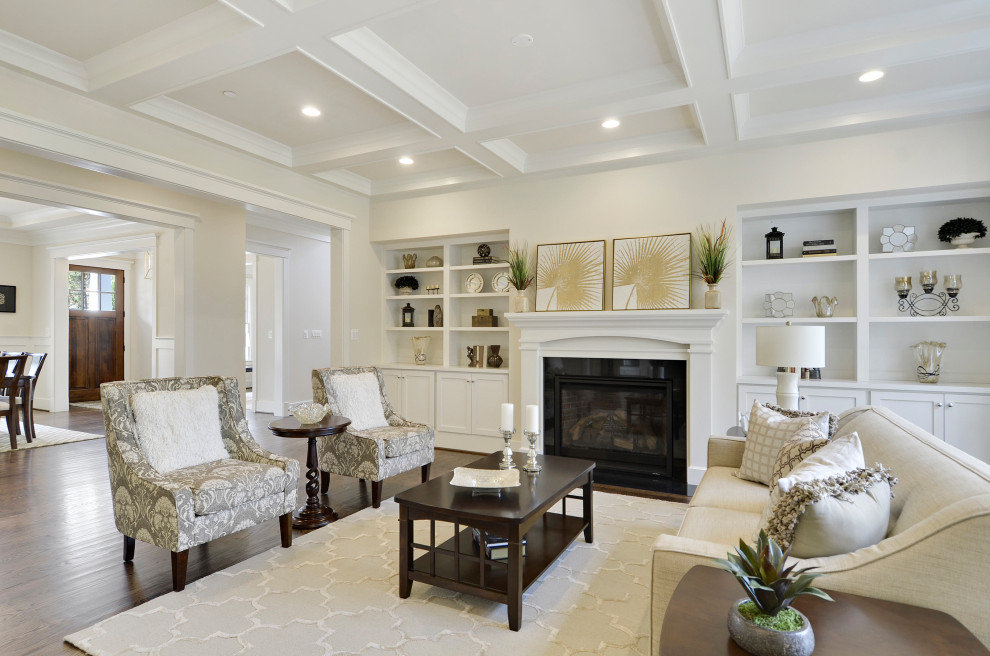 Photo of a large transitional formal open concept living room in DC Metro with beige walls, medium hardwood floors, a standard fireplace, a plaster fireplace surround, no tv, brown floor and coffered.