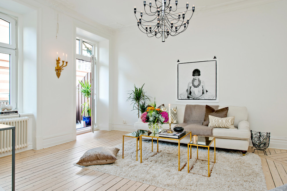 Inspiration for a large scandinavian formal open concept living room in Gothenburg with white walls, light hardwood floors, no fireplace and no tv.