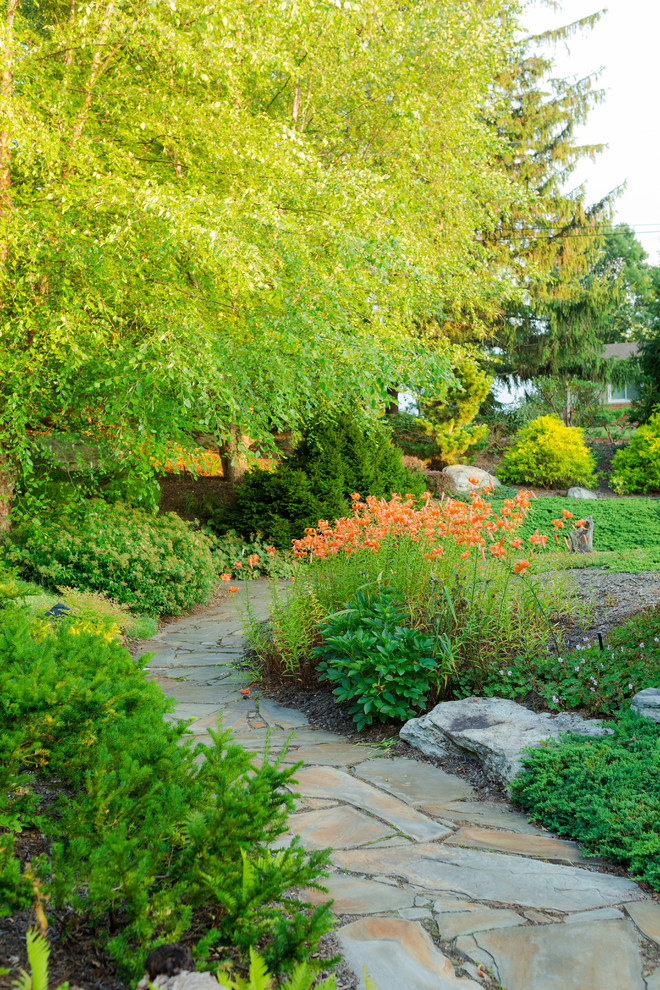 Design ideas for a mid-sized asian backyard full sun garden for summer in Charlotte with natural stone pavers.