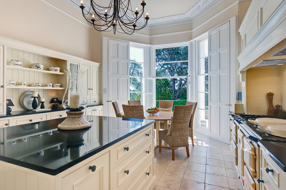 Traditional u-shaped separate kitchen in Devon with beaded inset cabinets, white cabinets, granite benchtops, coloured appliances and with island.