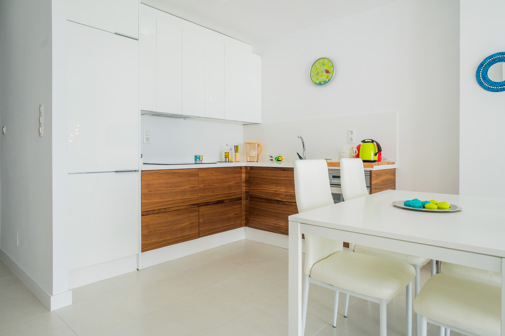 Design ideas for a small eclectic kitchen/dining combo in Malaga with white walls, ceramic floors and no fireplace.