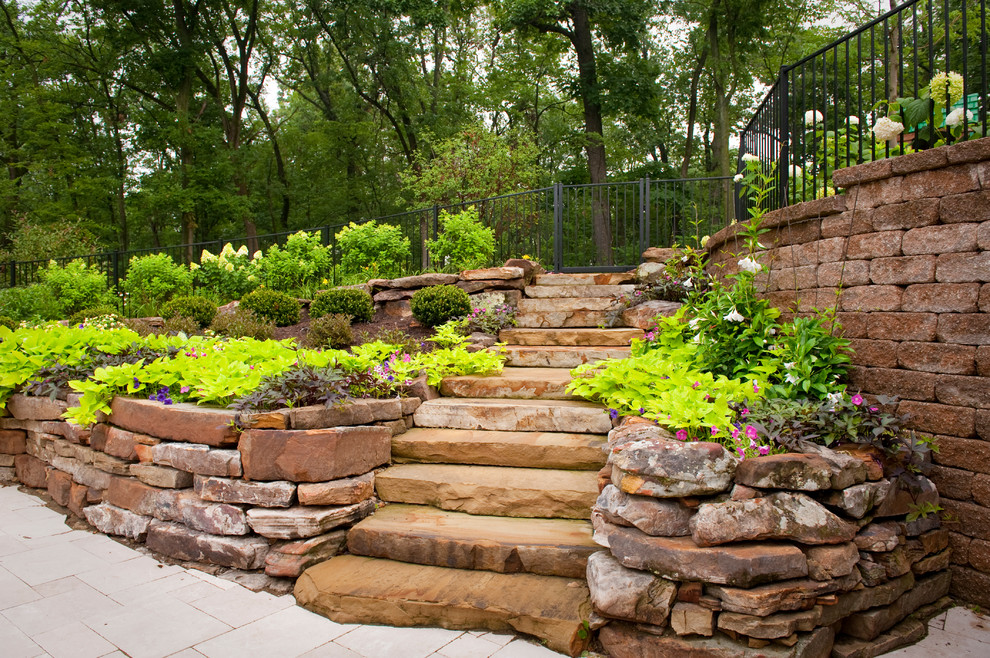 Photo of a large traditional garden in St Louis with a garden path and natural stone pavers.